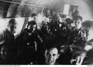 PORT MORESBY-WAU, NEW GUINEA, 1942-05-23. MEMBERS OF C PLATOON, 2/5TH INDEPENDENT COMPANY ABOARD THE US ARMY AIR FORCE DOUGLAS C47 AIRCRAFT "FLAMING MAMEY" DURING THEIR MOVE FROM PORT MORESBY TO ..