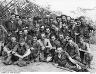 PAPUA, NEW GUINEA. 1942-10-01. TIRED, BUT HAPPY. AUSTRALIAN SOLDIERS OF THE 2/33RD BATTALION AT IORIBAIWA RIDGE. STANDING AT BACK: JOHN SAVAGE, JOHN HUGHES, "BONNIE" NEEDIMAN, "TEX" SHIELDS, JIM ..