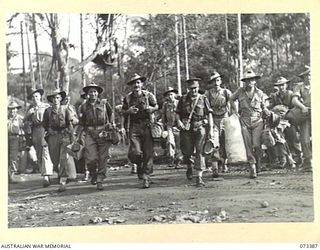 LAE, NEW GUINEA. 1944-05-24. TROOPS FROM HEADQUARTERS NEW GUINEA FORCE MOVING ON PARADE BEFORE BEING TRANSPORTED TO THE WHARF FOR THEIR JOURNEY HOME ON LEAVE