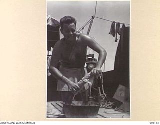 BORAM, NEW GUINEA. 1945-10-19. SAPPER J.N. PAVOUR, 43 LANDING CRAFT COMPANY, DOING HIS WASHING ON A LANDING CRAFT, TANK