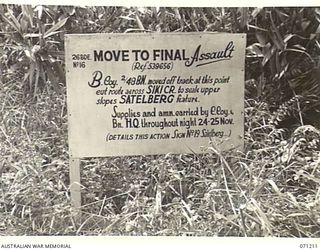 FINSCHHAFEN AREA, NEW GUINEA, 1944-03-17. ONE OF THE MANY BATTLE SIGNS IN THE FINSCHHAFEN AREA, THIS SIGN INDICATES THE POINT OF MOVEMENT TO FINAL ASSAULT BY "B" COMPANY, 2/48TH INFANTRY BATTALION, ..