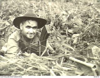 BABIANG, NEW GUINEA. 1944-11-07. TROOPER H.D. BURKE, SQUADRON HQ, 2/10 COMMANDO SQN, AT HIS BREN GUN DURING A PATROL