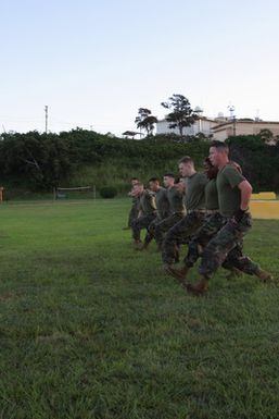 US Marine Corps (USMC) Marines, Headquarters and Service Battalion (H&S BN), Marine Forces Pacific (MARFORPAC), Camp H. M. Smith, Hawaii (HI), perform Squad Lunges, while participating in a unit wide conditioning exercise to enhance their combat readiness and improve their personal physical fitness