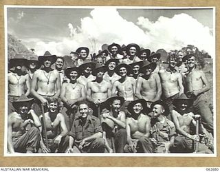 LAKE ROAD, FINISTERRE RANGES, NEW GUINEA. 1943-12-21. GROUP PORTRAIT OF PERSONNEL OF THE 2/14TH AUSTRALIAN INFANTRY BATTALION WHO ASSISTED THE ROYAL AUSTRALIAN ENGINEERS TO BUILD THE LAKE ROAD