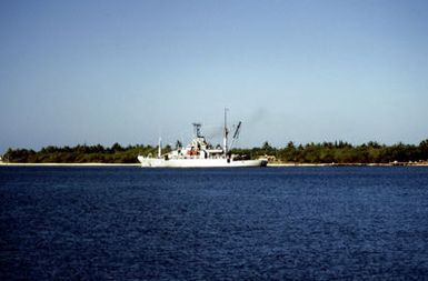 A port quarter view of the salvage ship USS SALVOR (ARS 52) departing the channel