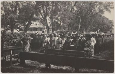 People standing at a formal ceremony