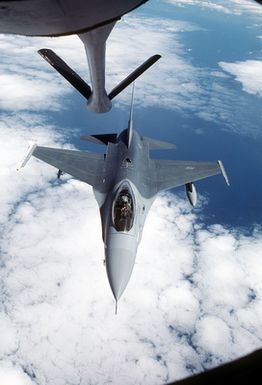 Top view of an F-16 Fighting Falcon aircraft, from the 428th Tactical Fighter Squadron, approaching the refueling boom of a KC-135 Stratotanker aircraft, to be refueled while en route to Hawaii to participate in Exercise Cope Elite