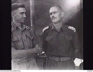 CAPE WOM, WEWAK AREA, NEW GUINEA. 1945-09-01. CAPTAIN J.R. HIRST, SC (A) (1) AND CAPTAIN G.N. FISHER, DEPUTY ASSISTANT ADJUTANT GENERAL (L) (2), STAFF OFFICERS OF HEADQUARTERS 6 DIVISION