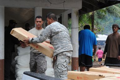 Earthquake ^ Tsunami - Asili, American Samoa, October 7, 2009 -- Army Reservists and local community members work side-by-side to establish a supply distribution center. FEMA coordinated the logistics and location in support of American Samoa as they recover from an earthquake and a tsunami. David Gonzalez/FEMA