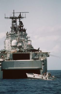 An LCM-8 mechanized landing craft backs out of the well deck of the amphibious assault ship USS SAIPAN (LHA 2) during Operation Sharp Edge. Marines embarked aboard the SAIPAN are being sent to the U.S. Embassy in Monrovia, Liberia, to augment security and evacuate U.S. and foreign nationals from the fighting between government and rebel forces