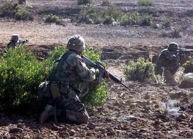 2nd Battalion, 3rd Marines, Echo Company, armed with M16 rifles, run the assault course at Pohakuloa Training Area on the Big Island of Hawaii