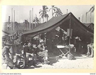BORAM BEACH, WEWAK AREA, NEW GUINEA. 1945-08-30. MEMBERS OF HEADQUARTERS 8 INFANTRY BRIGADE, LINED UP OUTSIDE THE REGIMENTAL AID POST