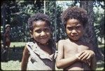 Children, girl (l) wears turtle shell earrings and shell necklace