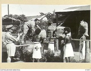 1942-12-17. NEW GUINEA. RED CROSS. SACKS OF CHRISTMAS PARCELS WHICH WILL BE DROPPED FROM TRANSPORT PLANES IN THE KOKODA AND MYOLA AREAS. (NEGATIVE BY BOTTOMLEY)