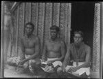 Men seated in front of a house, probably on Sikaiana