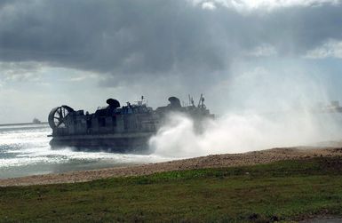 A US Navy (USN) Landing Craft, Air Cushioned (LCAC) leaves the beach at Inner Apra Harbor, Guam, returning to its support ship. The LCAC is here taking part in Exercise TANDEM THRUST 2003