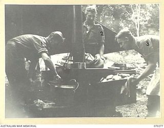 DUMPU, RAMU VALLEY, NEW GUINEA, 1944-02-11. COOKS OF "B" COMPANY 57/60TH INFANTRY BATTALION AT WORK, VX144644 PRIVATE T.W. WILSON (1); V245464 PRIVATE D. DASVIES (2); V43209 CORPORAL L.E. O'BRIEN ..