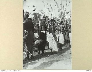 MALAHANG, LAE, NEW GUINEA. 1944-12-25. NATIVES PARTICIPATING IN THE SING-SING HELD IN THE AUSTRALIAN NEW GUINEA ADMINISTRATIVE UNIT NATIVE COMPOUND