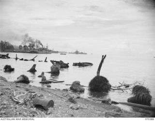 MILNE BAY, NEW GUINEA, 1944-02-12. THE TWISTED REMAINS OF TWO JAPANESE BARGES MARKING ONE OF THEIR UNSUCCESSFUL ATTACKING POINTS IN 1942-08