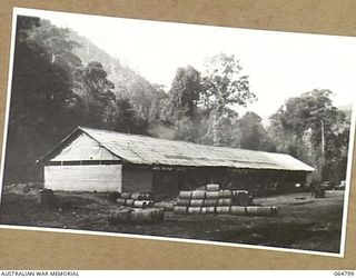 WAU, NEW GUINEA. 1944-02-11. MACHINERY SHED AND WORKSHOP OF THE 2/4TH FIELD SQUADRON, ROYAL AUSTRALIAN ENGINEERS WHILE THE UNIT WAS WORKING ON THE NEW WAU ROAD