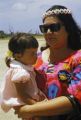 Federated States of Micronesia, woman holding child at airport on Pohnpei Island