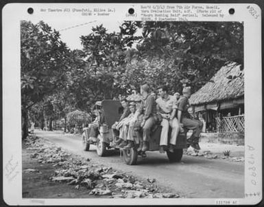 Through The Native Village At Funafuti Army Air Force Fliers Drive To Their Quarters. (U.S. Air Force Number 121708AC)