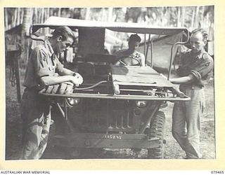 KALAI PLANTATION, NEW BRITAIN. 1945-03-06. PERSONNEL OF THE 6TH FIELD AMBULANCE PREPARING ONE OF THE UNIT AMBULANCE JEEPS FOR EVACUATION DUTY IN THE FORWARD AREA. IDENTIFIED PERSONNEL ARE: VX133769 ..