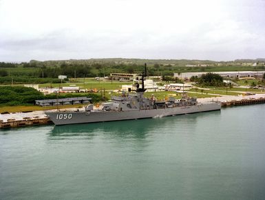 A port view of the frigate USS ALBERT DAVID (FF 1050) moored at a pier