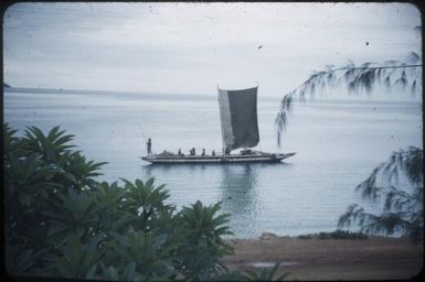 Native canoe being poled along in shallow water, off Ela Beach : Port Moresby, Papua New Guinea, 1953 / Terence and Margaret Spencer