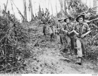 WEWAK AREA, NEW GUINEA, 1945-07-13. PERSONNEL OF B COMPANY, 2/8 INFANTRY BATTALION, ADVANCING IN SUPPORT OF A COMPANY'S ASSAULT ON "THE BLOT"