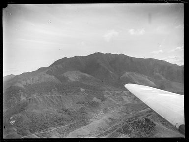 View of forest covered mountain and valley with road, New Caledonia