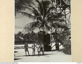 PERSONNEL OF THE AIR MOVEMENT SECTION FIELD HEADQUARTERS, ROYAL NEW ZEALAND AIR FORCE AT OCEAN TOWER. IDENTIFIED PERSONNEL ARE:- AIRCRAFTMAN CLASS I, K.T. BURNS (1); FLYING OFFICER C. LIVERTON (2); ..