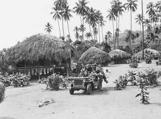 KAIAPIT, NEW GUINEA, 1943-09-22. TROOPS OF THE 2/6TH AUSTRALIAN INDEPENDENT COMPANY ON A JEEP DRIVING THROUGH KAIAPIT VILLAGE