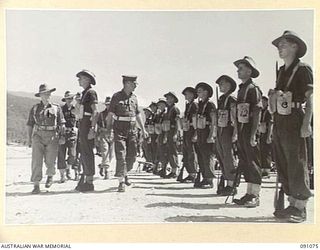 JACQUINOT BAY, NEW BRITAIN. 1945-04-21. BRIGADIER C R V EDGAR COMMANDER 4 INFANTRY BRIGADE (4), ACCOMPANIED BY LIEUTENANT COLONEL F J EMBREY COMMANDING OFFICER 37/52ND INFANTRY BRIGADE (1), AND ..