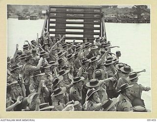 LAE, NEW GUINEA, 1945-05-07. HEADING FOR THE SHORE AUSTRALIAN WOMEN'S ARMY SERVICE WAVE FROM THE LANDING BARGE TO THEIR SHIPMATES STILL ABOARD THE MV DUNTROON. THEY ARE PART OF A GROUP OF 342 ..