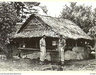 LAE, NEW GUINEA. 1944-04-01. LIEUTENANT (SP) NASH (1), (INTELLIGENCE OFFICER), ROYAL AUSTRALIAN NAVAL VOLUNTEER RESERVE, WITH O/N21193 PETTY OFFICER TELEGRAPHIST S.T. CLARK (2), OUTSIDE THE RADIO ..