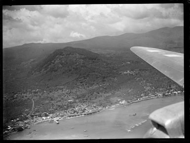 Apia Harbour coastal settlement with forest covered mountains beyond, Western Samoa