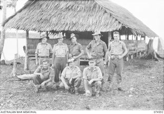 MALAMAL, NEW GUINEA. 1944-07-13. MEMBERS OF THE STAFF OF THE AUSTRALIAN NEW GUINEA ADMINISTRATIVE UNIT NATIVE LABOUR COMPOUND. IDENTIFIED PERSONNEL ARE:- VX53075 CORPORAL V.G. TUSKIN (1); QX19703 ..