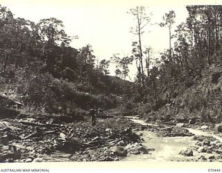 FARIA RIVER, NEW GUINEA, 1944-02-15. MEMBERS OF THE 57TH/70TH INFANTRY BATTALION MOVING ALONG THE FARIA RIVER ON THE MARCH TO THE FINISTERRE RANGE TO RELIEVE MEMBERS OF THE 18TH INFANTRY BRIGADE. ..