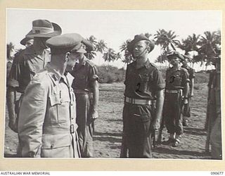 AITAPE, NEW GUINEA. 1945-04-17. MAJOR GENERAL J.E.S. STEVENS, GENERAL OFFICER COMMANDING 6 DIVISION (1), INSPECTING PERSONNEL OF REGIMENTAL HEADQUARTERS 2/6 CAVALRY (COMMANDO) REGIMENT. THE PARADE ..