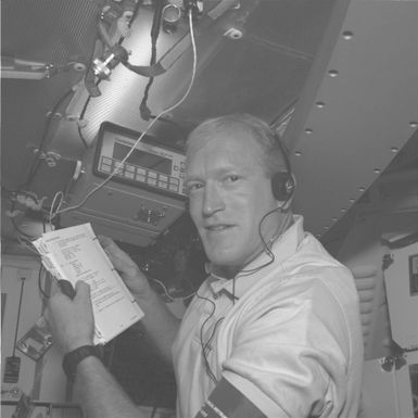 STS-48 MS Gemar, reviewing checklist on OV-103's middeck, is captured by ESC