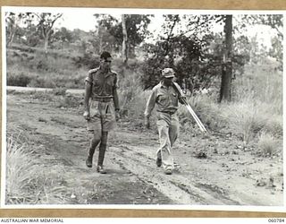 POM POM VALLEY, NEW GUINEA. 1943-11-27. VX117252 CAPTAIN G. H. NICHOLSON (1) AUSTRALIAN MILITARY HISTORY SECTION, ARRIVING AT THE PARADE GROUND IN PREPARATION FOR THE TAKING OF A TRAINING FILM FOR ..