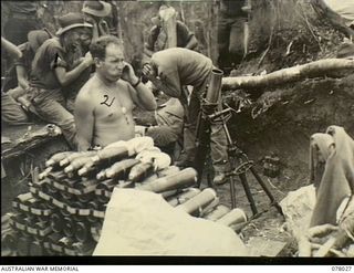 Piaterapaia Area. Bougainville. 1944-12-30. A three inch Mortar crew of the 25th Infantry Battalion, 7th Australian Army Brigade, firing their weapon at Japanese positions under attack by members ..