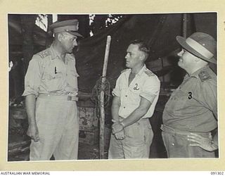 MOTUPENA POINT, BOUGAINVILLE. 1945-04-27. MAJOR-GENERAL C.H. SIMPSON, SIGNAL OFFICER- IN- CHIEF (1), WITH CAPTAIN L.W. ARMSTRONG, 4 LINE SECTION B CORPS SIGNALS (2), AND COLONEL R.C. REEVE, CHIEF ..