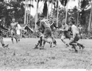 SOUTH ALEXISHAFEN, NEW GUINEA. 1944-09-10. AN EXCITING INCIDENT DURING THE RUGBY LEAGUE FOOTBALL MATCH BETWEEN TEAMS FROM THE 61ST INFANTRY BATTALION "THE QUEENSLAND CAMERON HIGHLANDERS" AND THE ..