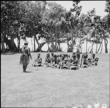 A group of Fijian men performing songs, dressed in traditional costumes, Nasalai, Fiji, 1966 / Michael Terry