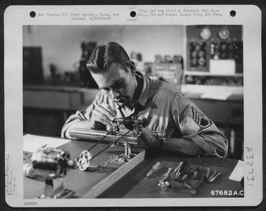 A "GI" uses a jeweler's lathe to make a pivot screw for an altimeter at the instrument shop of the 27th Air Depot Group at the Port Moresby Air Depot, Papua, New Guinea. 1943. (U.S. Air Force Number 67682AC)