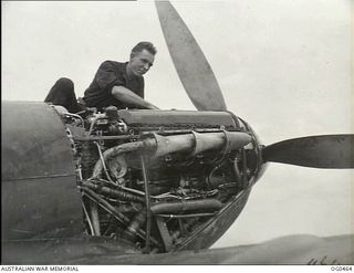 KIRIWINA, TROBRIAND ISLANDS, PAPUA. 1944-01-11. THE SPITFIRE AIRCRAFT ENGINE IS A WONDER OF SMOOTHLY WORKED PARTS AND INTRICATE WIRING. LEADING AIRCRAFTMAN F. N. CARROLL OF PETERSHAM, VIC HAS THE ..