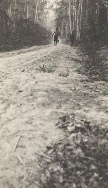 Two men walking along the Bita Paka road between Kabakaul and Bita Paka, German New Guinea, 1914