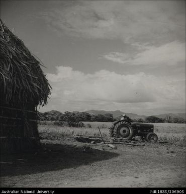 Farmer riding tractor